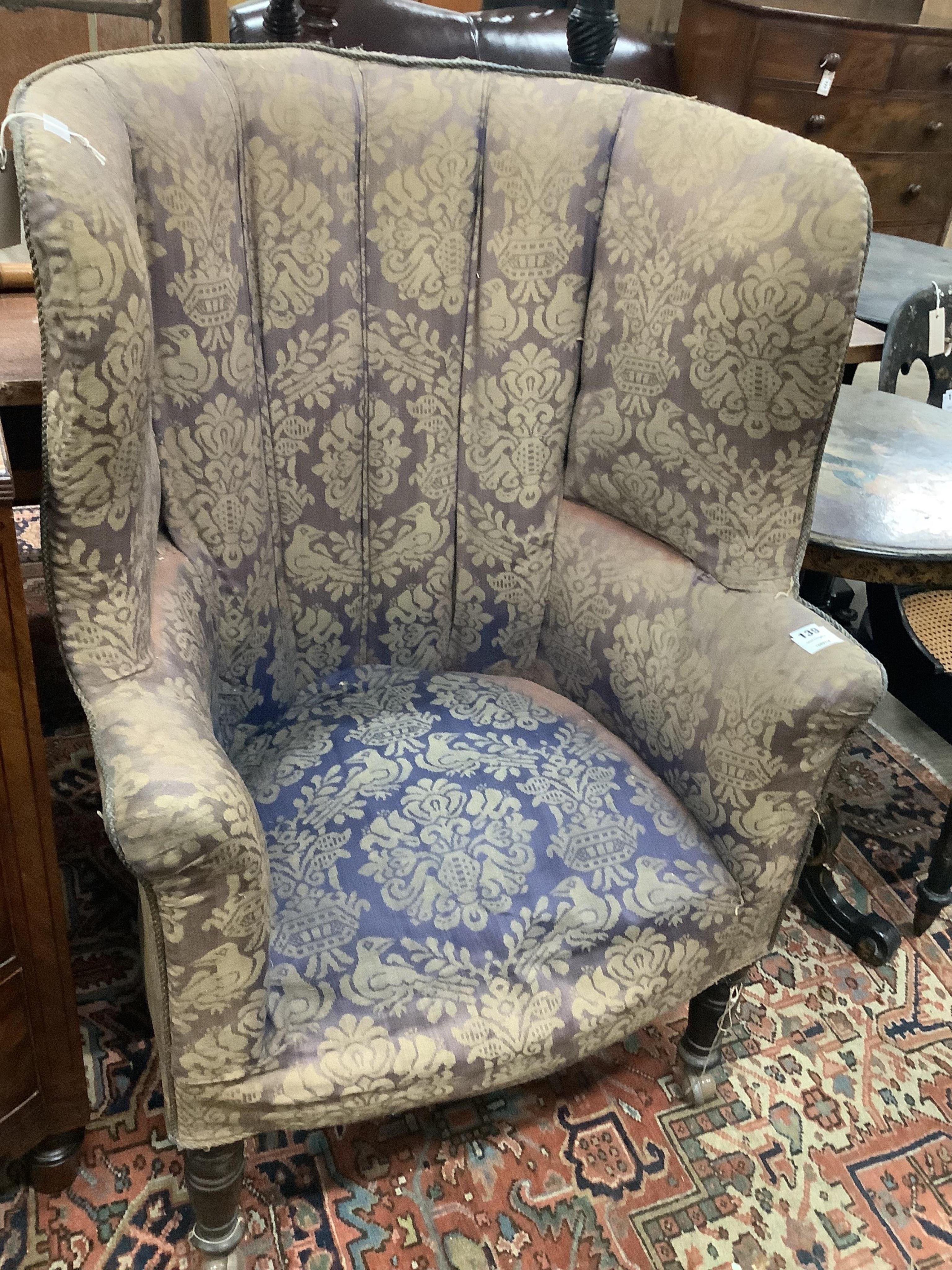 An early 19th century upholstered tub framed wing armchair, width 73cm, depth 55cm, height 113cm. Condition - fair